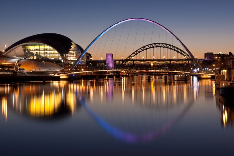 Newcastle and Gateshead at sundown showing Gateshead Millennium Bridge and Tyne Bridges
